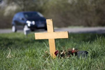 Wooden cross on the side of the road