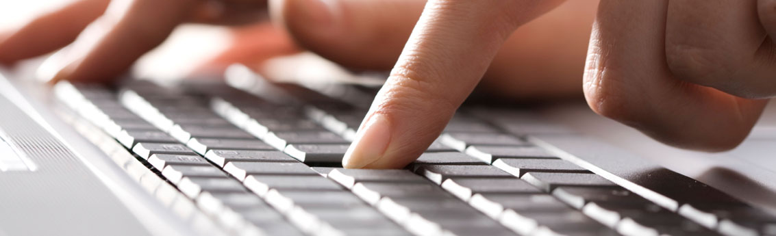 Fingers typing on laptop keyboard